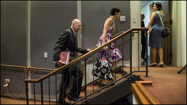 Sam Hirsch from the Department of Justice and Rhea Suh with the Department of the Interior leaves auditorium with other members of panel after a public meeting on whether the United States should establish a government-to-government relationship with Hawaii’s indigenous community held at the Hawaii State Capitol auditorium on June 23, 2014
