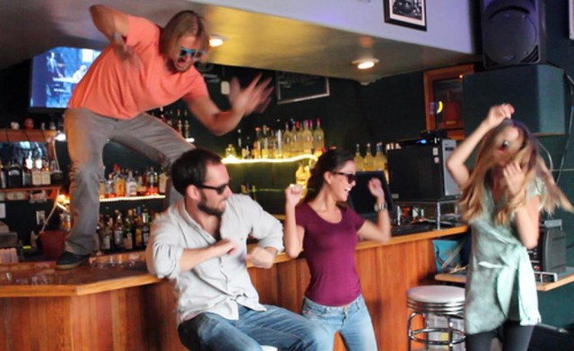 Random people dance in a bar in Honolulu.