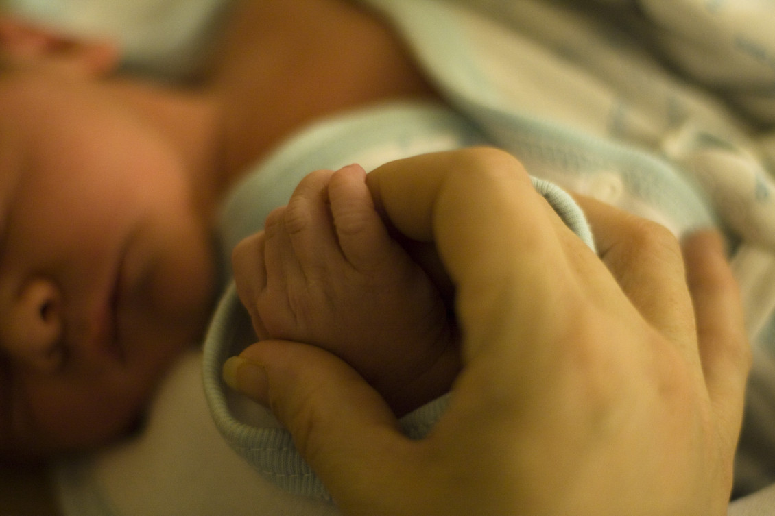 newborn holding hands