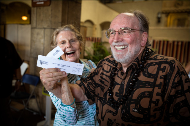 Gov. Neil Abercrombie and wife Nancie Caraway show election receipts after casting their Primary votes on August 6, 2014
