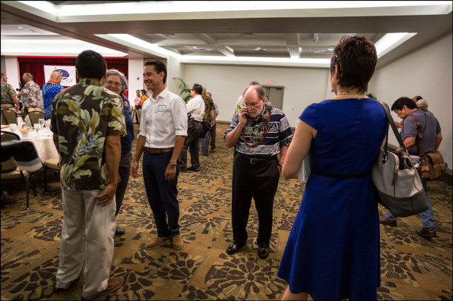 Gov. Neil Abercrombie attends to business at the start of the Democratic Party Unity Breakfast on August 10, 2014
