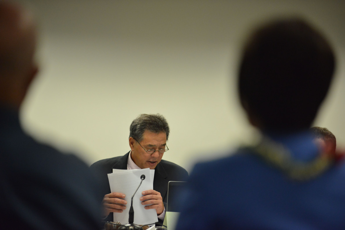 Special Investigative Committee on the Hawaii State Hospital Co-Chair Senator Clayton Hee reads findings in a report during hearings on October 22, 2014. 12pm.  photograph by Cory Lum.