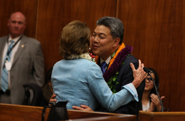 Representative Mark Takai gives a congratulatory kiss to Minority Leader of the United States House of Representatives Nancy Pelosi after Takai took his oath of office .  16 jan 2015 photograph Cory Lum/Civil Beat