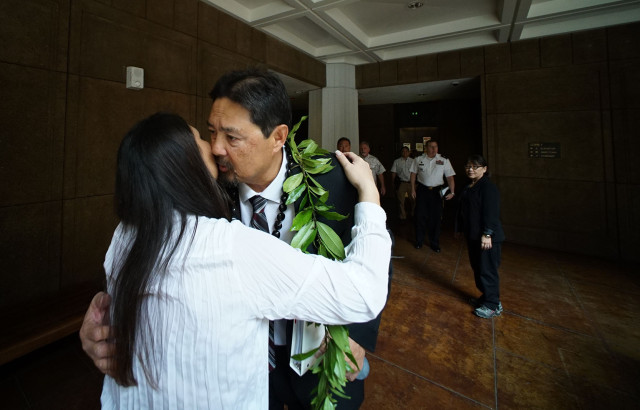 Chair DLNR candidate Carleton Ching receives a lei before senate confirmation hearing at the Capitol. 11 march 2015. photograph Cory Lum