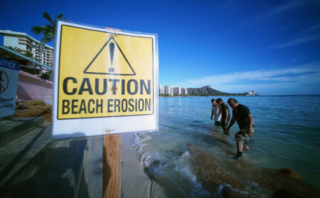 Small waves thrash the beach and sand in Waikiki. Honolulu. Hawaii. 2 march 2015. photograph cory Lum/Civil Beat