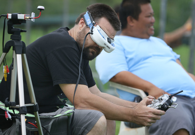 Drone racing pilots wear goggles and use their radio controllers to pilot and fly the small drones around a course at the Kawainui R/C Air Model Field near Kailua. 7 nov 2015. photograph Cory Lum/Civil Beat