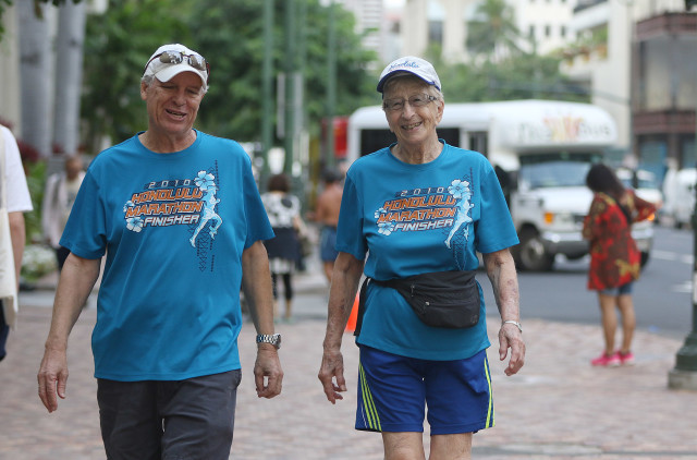 97-year-old Gladys Burrill walks with George McCarthy. 24 nov 2015. photograph Cory Lum/Civil Beat
