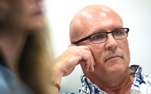 John Purcell, vice president of Monsanto, listens to testimony Tuesday at a joint House committee hearing.