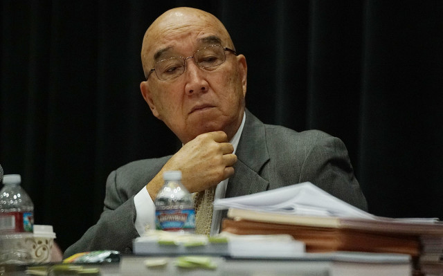 PUC Chair Randy Iwase massages his brows during intervenor testimony. 5 feb 2016. photograph Cory Lum/Civil Beat