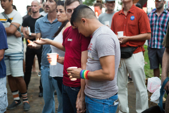 Mourners comfort one another at the Kapiolani Park candlelight vigil. 