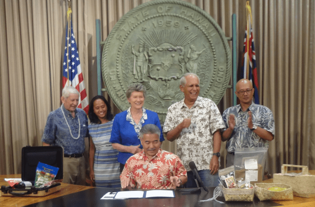 Bill supporters Sen. Sam Slom, Reps. Della Au Belatti and Cynthia Thielen and Sens. Mike Gabbard and Will Espero joing Gov. David Ige (seated) for the official bill signing on July 7.