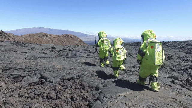 In this 2017 photo released by the University of Hawaii crew members of Mission V, walk across lava next to the university’s facility Hawaii Space Exploration Analog and Simulation (HI-SEAS) at the Mauna Loa volcano, Big Island, Hawaii. After eight months of living in isolation on a remote Hawaii volcano, six NASA-backed space psychology research subjects will emerge from their Mars-like habitat on Sunday, Sept. 17, 2017. The participants are in a study designed to better understand the psychological impacts of a long-term manned mission to space on astronauts. NASA hopes to send humans to Mars by the 2030s. (University of Hawaii via AP)