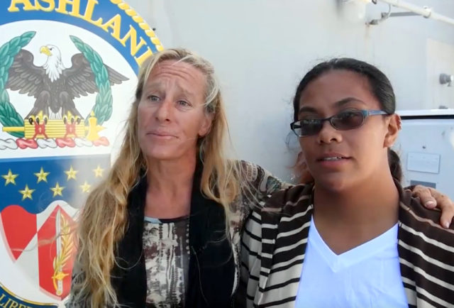 In this Wednesday, Oct. 25, 2017 frame from video provided by the U.S. Navy, Jennifer Appel, left, and Tasha Fuiava, who with their dogs were rescued after being lost at sea for several months while trying to sail from Hawaii to Tahiti, are interviewed aboard the USS Ashland in the South Pacific Ocean. The U.S. Navy rescued the women on Wednesday after a Taiwanese fishing vessel spotted them about 900 miles southeast of Japan on Tuesday and alerted the U.S. Coast Guard. The women lost their engine in bad weather in late May, but believed they could still reach Tahiti. (Mass Communication Specialist 3rd Class Jonathan Clay/U.S. Navy via AP)
