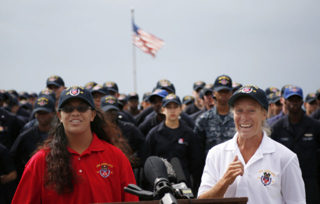 Jennifer Appel, right, and Tasha Fuiava speak on the deck of the USS Ashland at White Beach Naval Facility in Okinawa, Japan Monday, Oct. 30, 2017. The U.S. Navy ship arrived at the American Navy base, five days after it picked up the women and their two dogs from their storm-damaged sailboat, 900 miles southeast of Japan. (AP Photo/Koji Ueda)