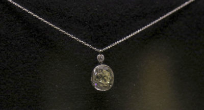 n this Friday, Jan. 26, 2018 photo, a nearly 14-carat diamond that Hawaiian King Kalakaua wore as a pinky ring is displayed at Iolani Palace in Honolulu. After the king died, the diamond was passed down through the royal family, eventually to Abigail Kawananakoa, who donated it to Iolani Palace. Kawananakoa, a 91-year-old Native Hawaiian heiress, is fighting her former lawyer over control of her $215 million fortune. (AP Photo/Caleb Jones)